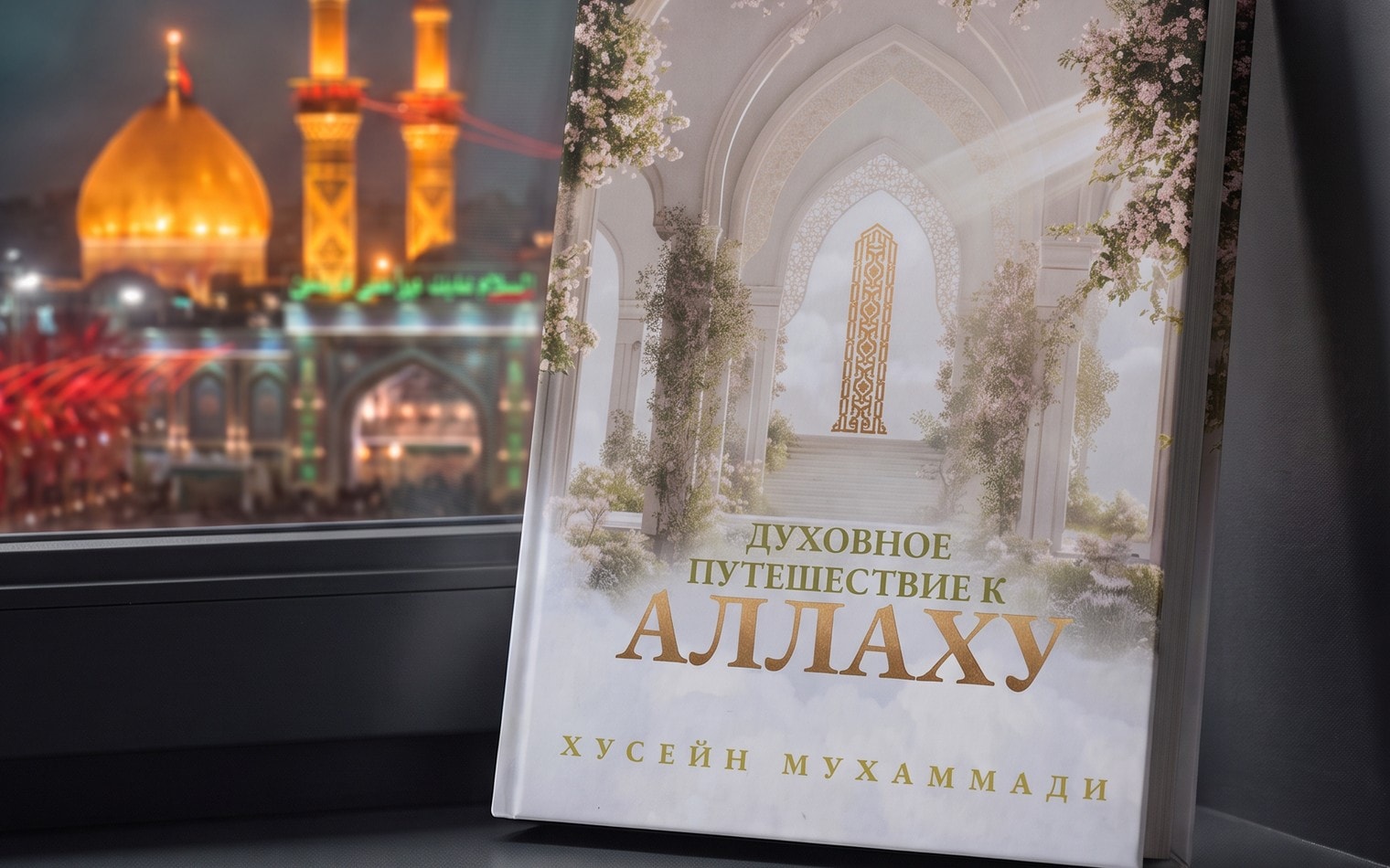 Книга «Духовное путешествие к Аллаху» у ночного окна, за стеклом — свет харама
